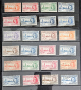 An assortment of vintage postage stamps featuring King George VI, with various colors and designs, displayed in a row.
