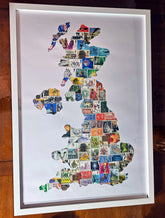 Framed artwork of a map of the United Kingdom made from postage stamps on a wooden surface.