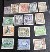 A collection of vintage British Guyana stamps from the reign of King George V, featuring various designs including portraits and imagery of local flora and fauna.