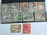 A collection of vintage British Guyana stamps from the reign of King George V, featuring various designs including portraits and imagery of local flora and fauna.
