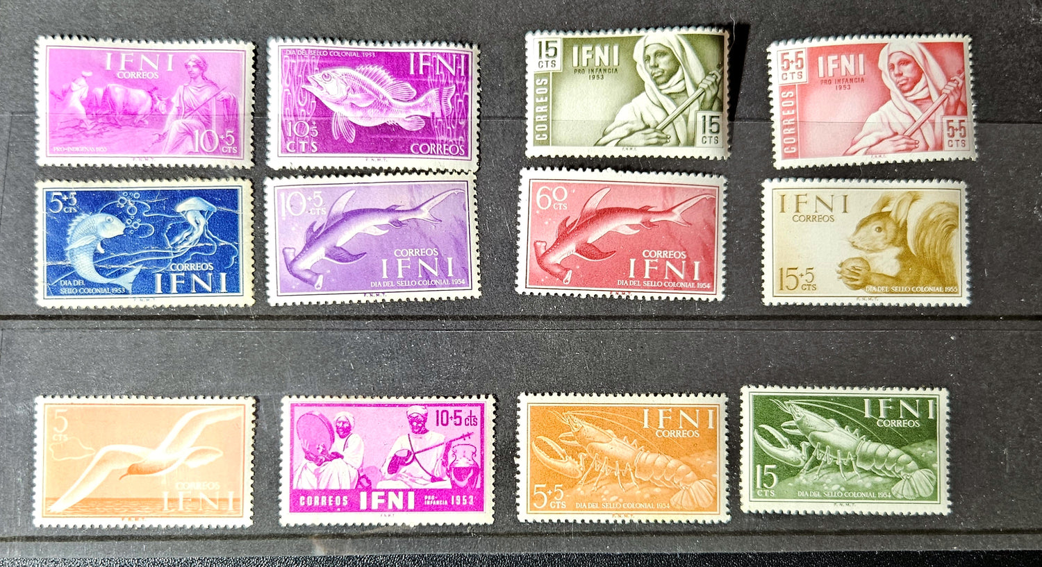 Collection of vintage stamps with different designs and colors on a black background