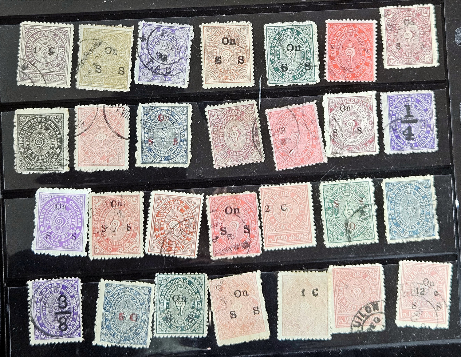 A collection of various Indian postage stamps displayed in a row, showcasing different colors and designs.