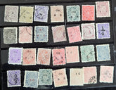 A collection of various Indian postage stamps displayed in a row, showcasing different colors and designs.