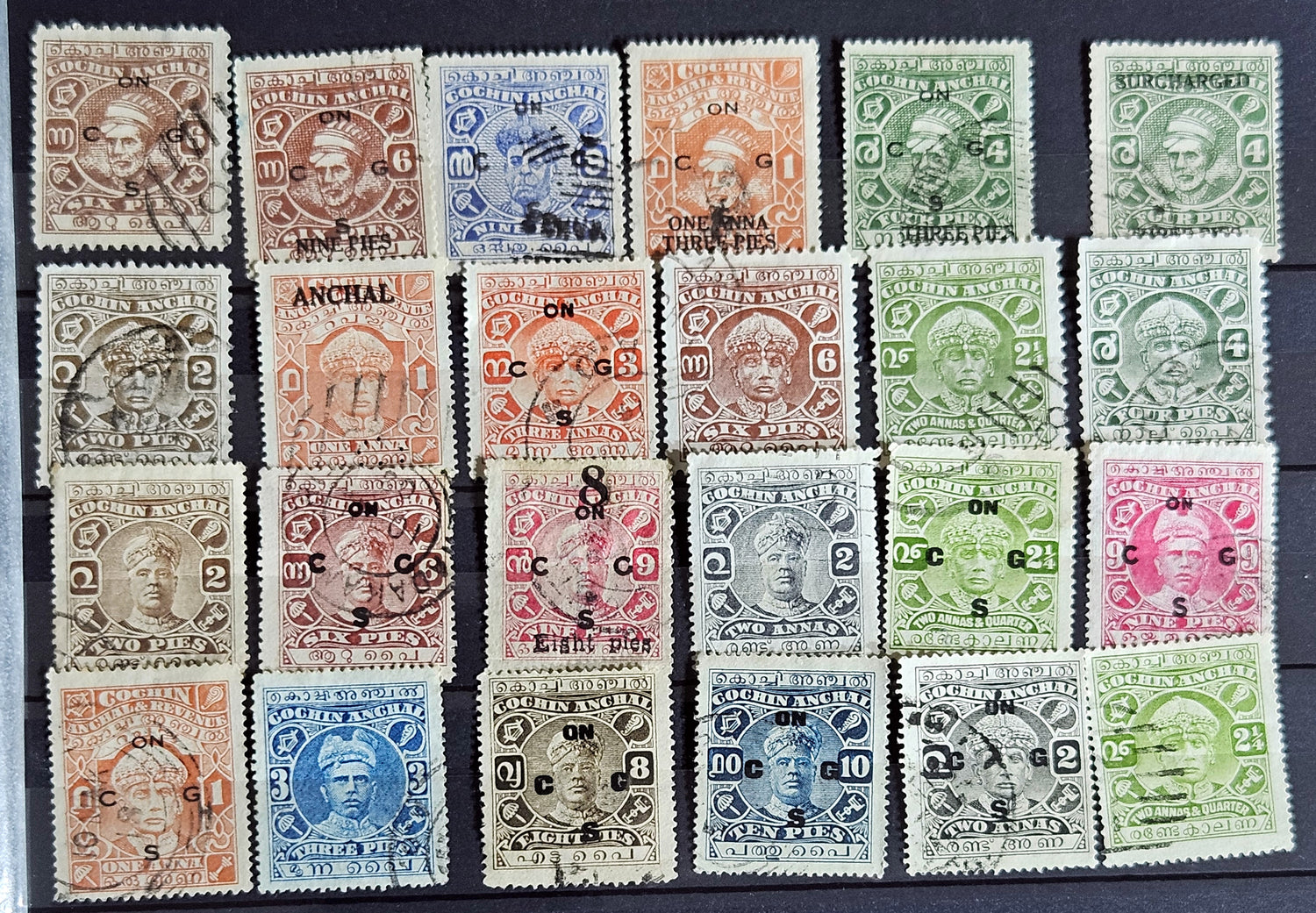 A collection of various Indian postage stamps displayed in a row, showcasing different colors and designs.