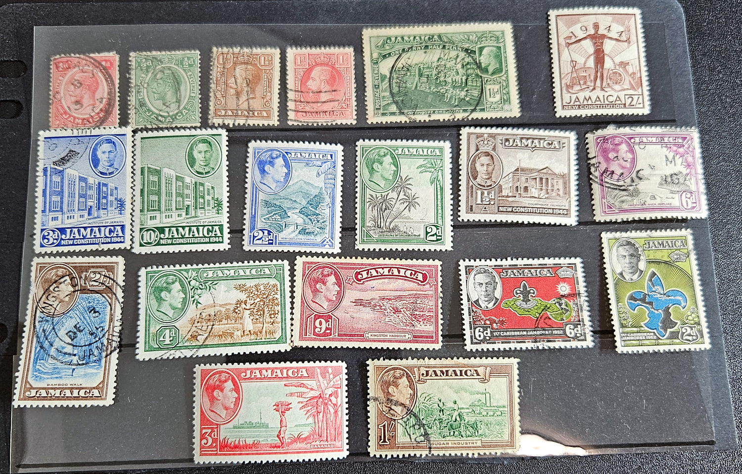 A collection of vintage Jamaica stamps from various reigns of British monarchs, displayed on a black background.