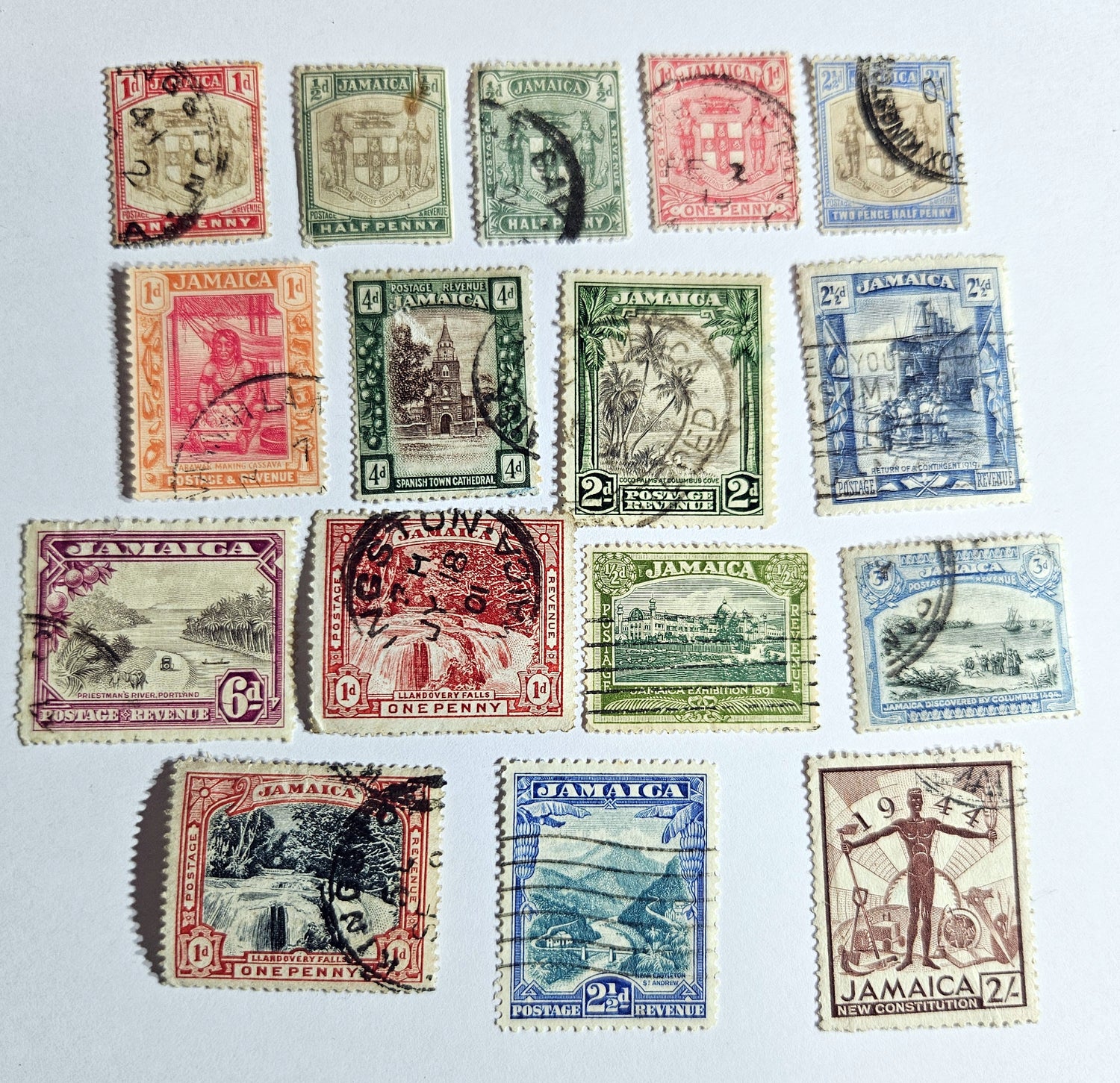A collection of vintage Jamaica stamps from various reigns of British monarchs, displayed on a black background.