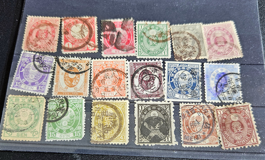A collection of vintage Japanese stamps from various eras, displayed on a flat surface.