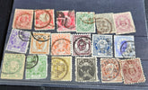 A collection of vintage Japanese stamps from various eras, displayed on a flat surface.