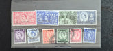 Collection of vintage stamps from Kuwait in a display case.