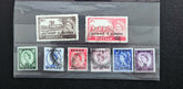 Collection of vintage Kuwait postage stamps in a display case.