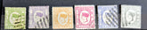 A collection of six vintage Labuan postage stamps with various designs, predominantly in green, blue, and brown shades, featuring inscription &