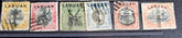 A collection of six vintage Labuan postage stamps with various designs, predominantly in green, blue, and brown shades, featuring inscription &