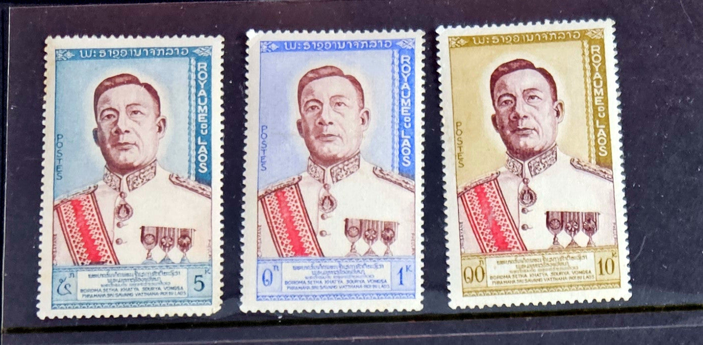 A set of vintage postage stamps from Laos featuring images of historical figures, traditional art, and natural beauty.