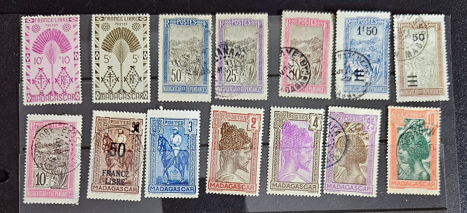 A set of vintage stamps from French Madagascar, featuring various designs including floral patterns and portraits.
