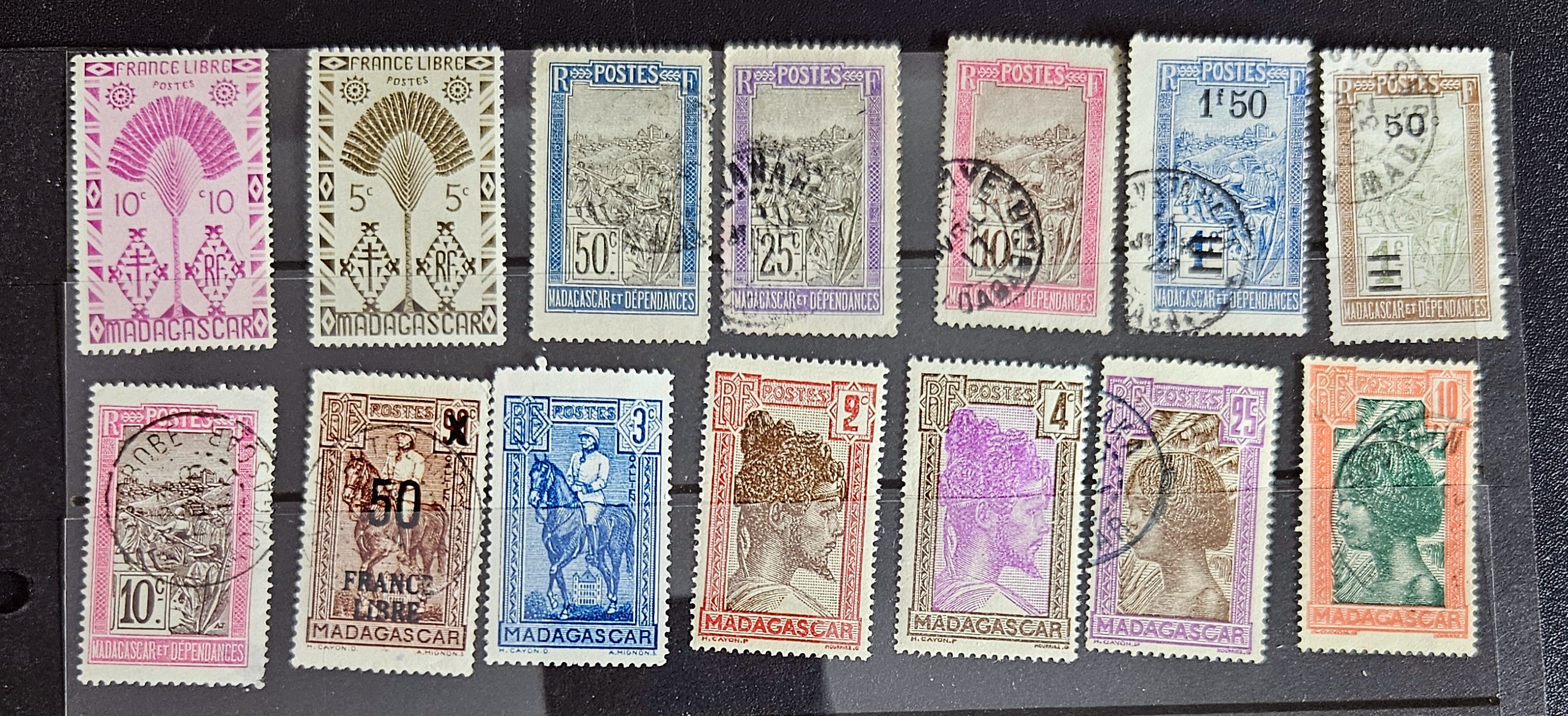 A set of vintage stamps from French Madagascar, featuring various designs including floral patterns and portraits.