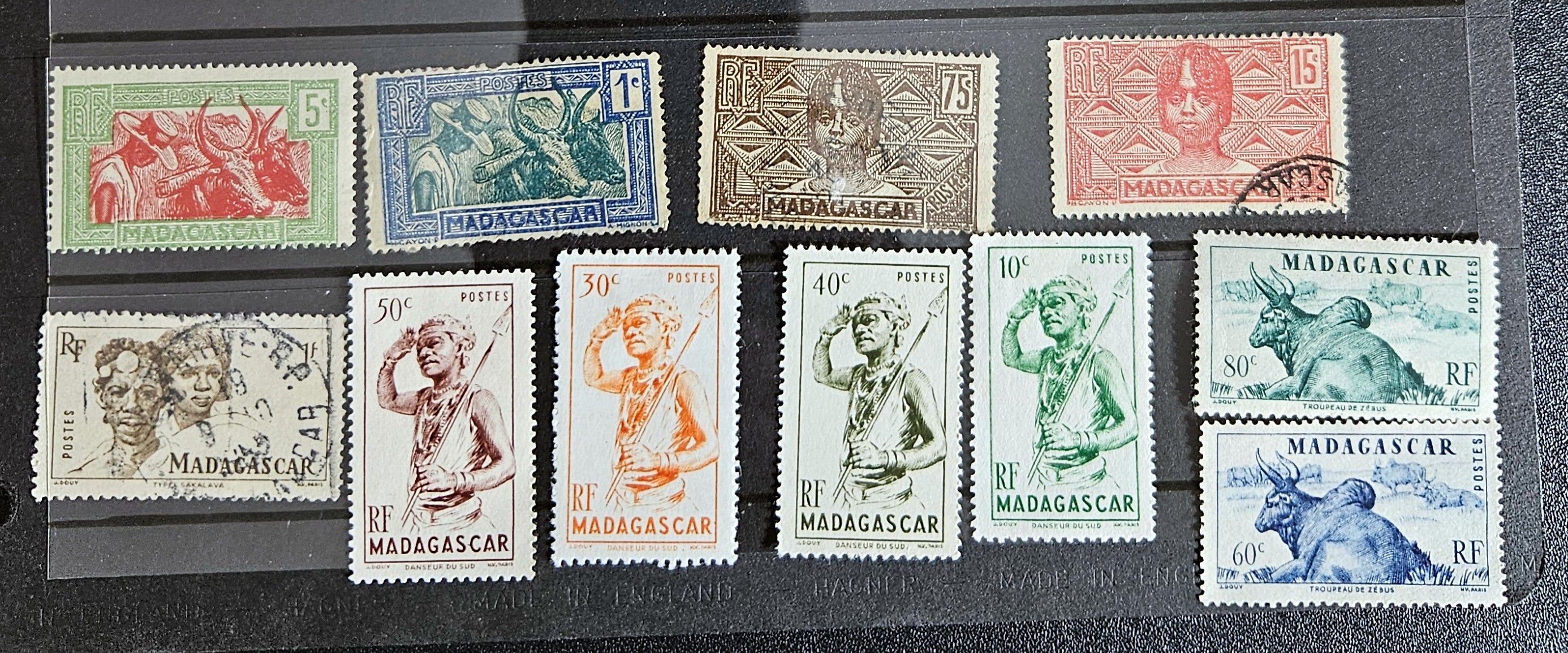 A set of vintage stamps from French Madagascar, featuring various designs including floral patterns and portraits.