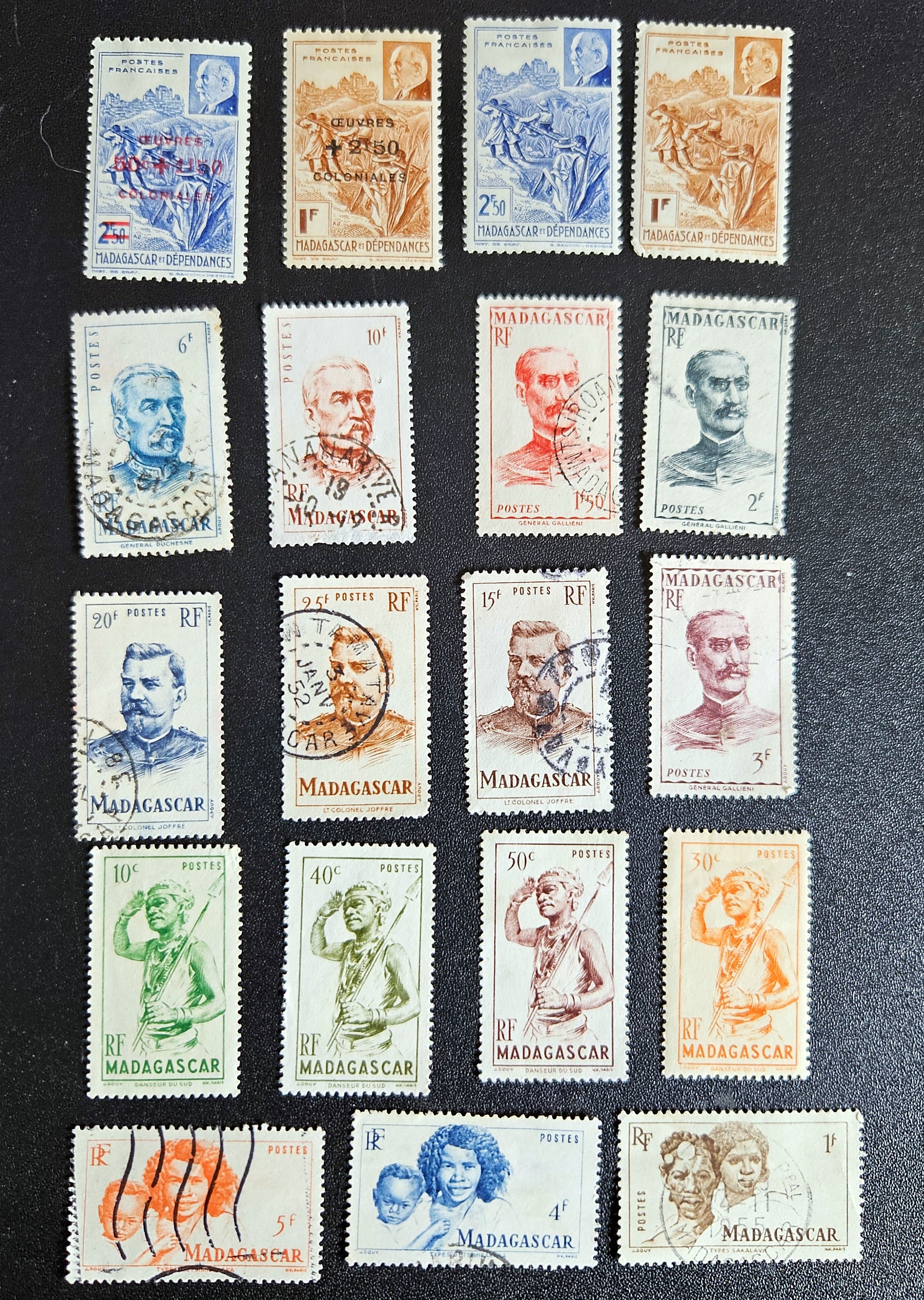 A set of vintage stamps from French Madagascar, featuring various designs including floral patterns and portraits.