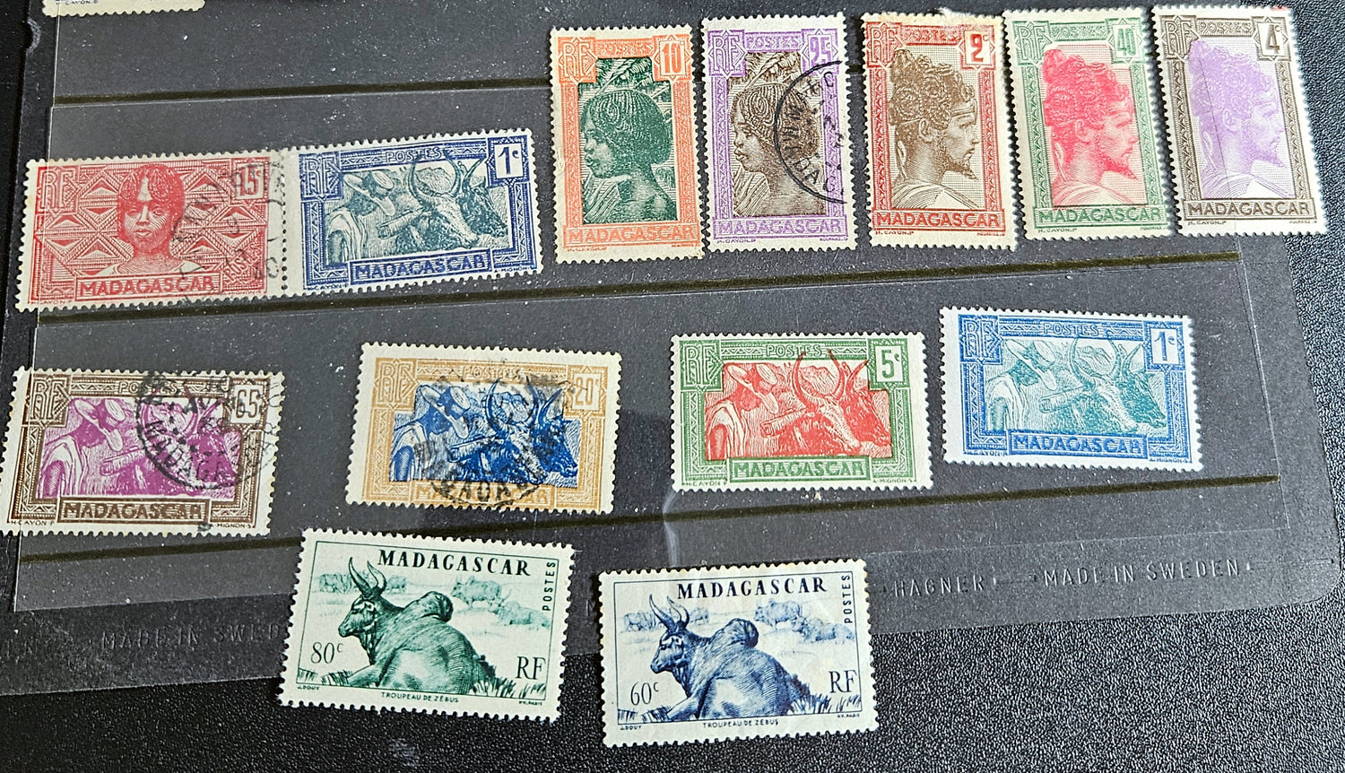 A set of vintage stamps from French Madagascar, featuring various designs including floral patterns and portraits.
