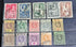 A collection of vintage British Nigeria stamps displayed on a surface, featuring various colors and motifs related to different eras in Nigerian history.