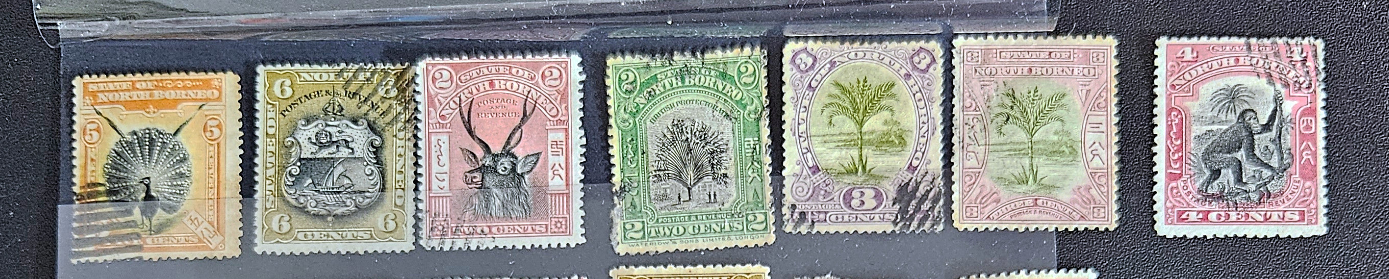 A set of vintage postage stamps from North Borneo and Sabah with various designs and denominations.