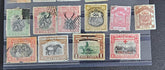 A set of vintage postage stamps from North Borneo and Sabah with various designs and denominations.