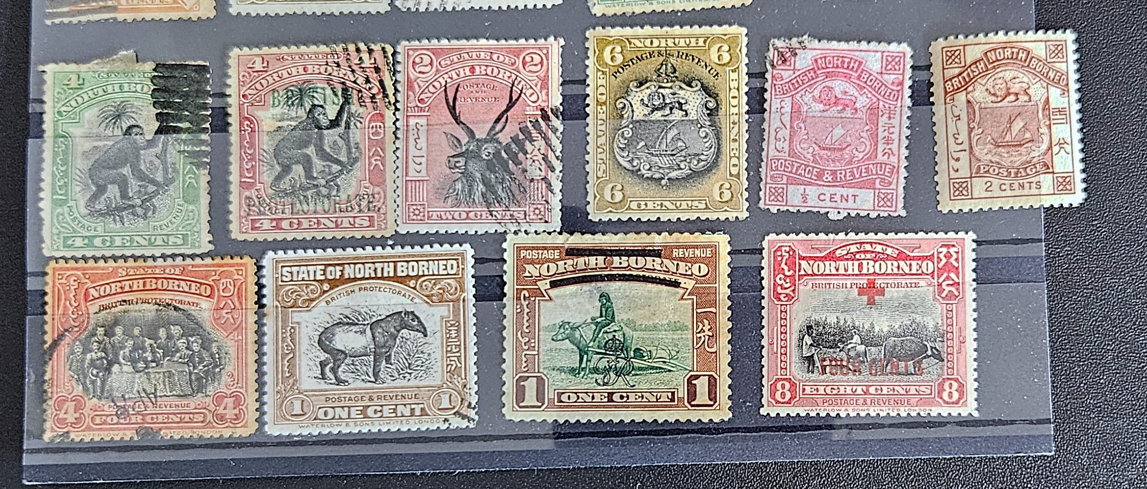 A set of vintage postage stamps from North Borneo and Sabah with various designs and denominations.