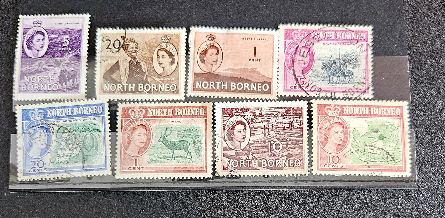 A set of vintage postage stamps from North Borneo and Sabah with various designs and denominations.