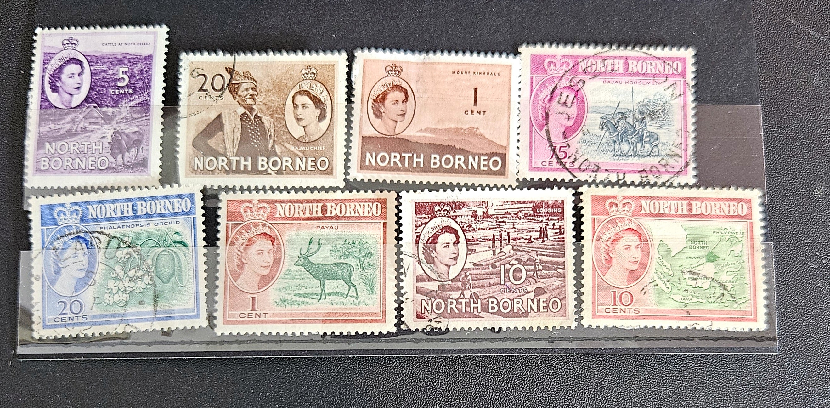 A set of vintage postage stamps from North Borneo and Sabah with various designs and denominations.