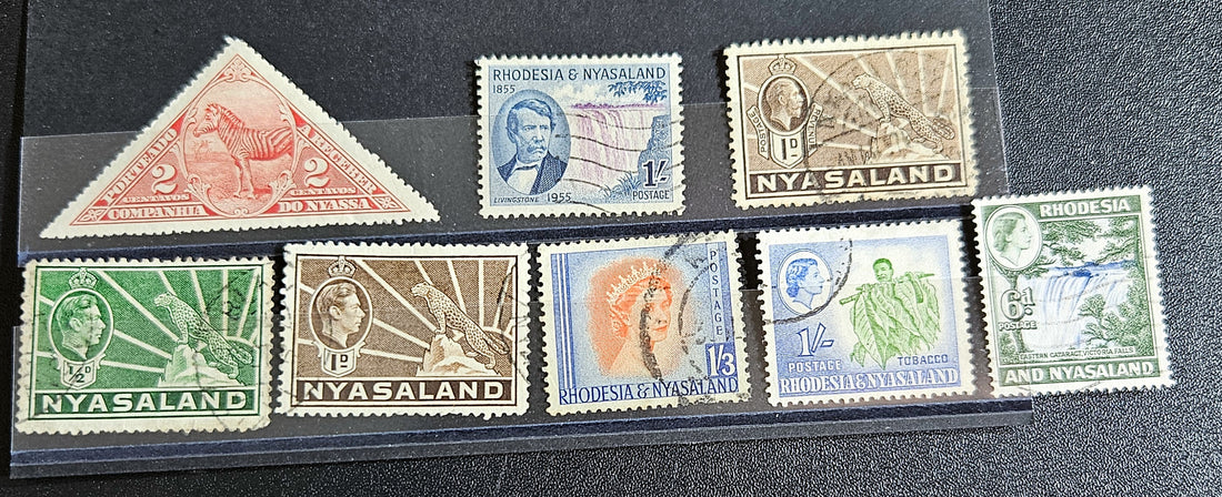 A collection of Nyasaland vintage stamps displaying various images and text, arranged in a row.