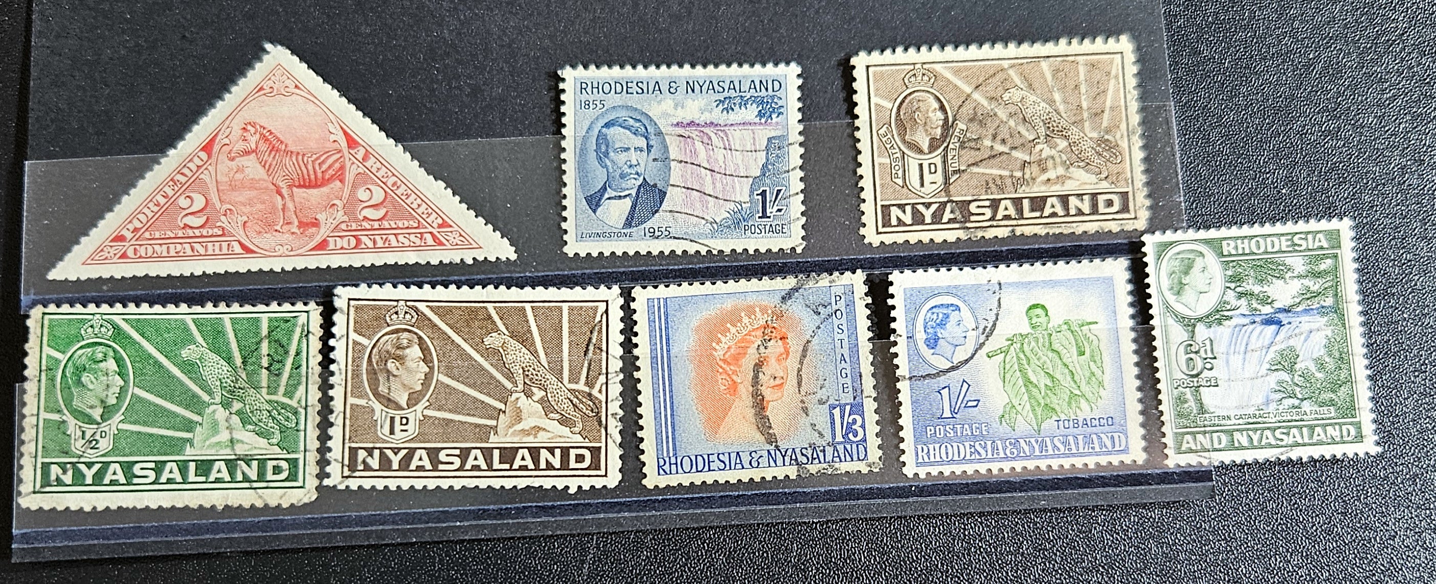 A collection of Nyasaland vintage stamps displaying various images and text, arranged in a row.