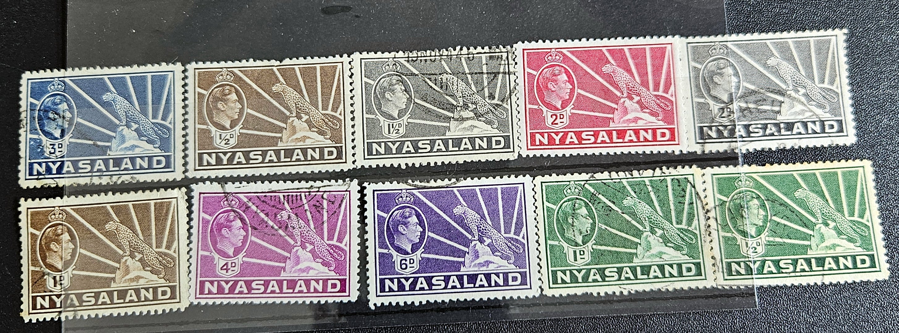A collection of Nyasaland vintage stamps displaying various images and text, arranged in a row.