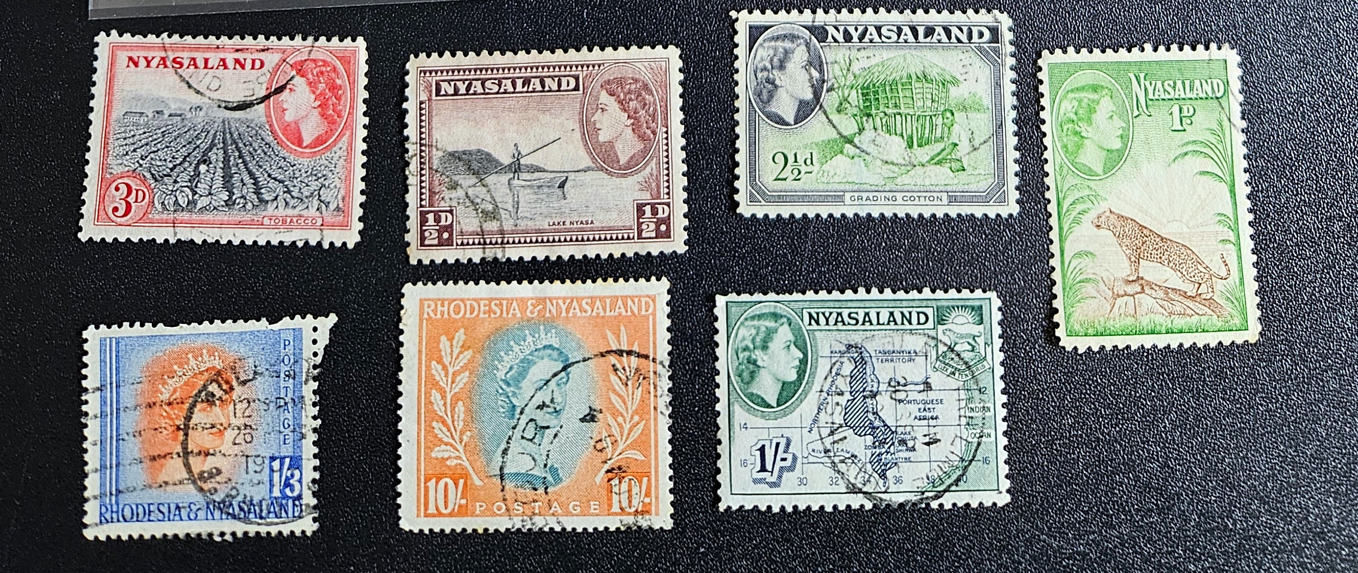 A collection of Nyasaland vintage stamps displaying various images and text, arranged in a row.