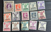 A collection of vintage Pakistan stamps from various periods, showing different designs and denominations, displayed on a glass surface.