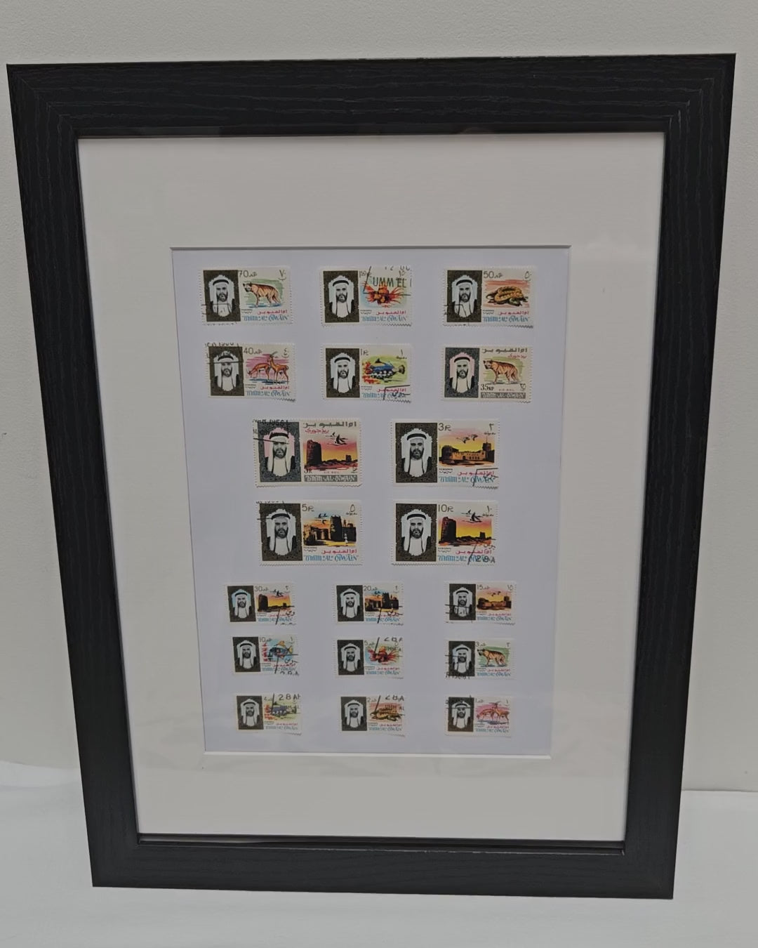 Umm Al Quwain Themed Vintage Stamp Collection in a photo frame