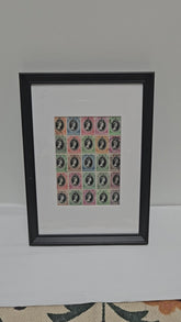 Framed print of vintage postage stamps with Queen Elizabeth portrait designs on a white background