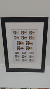 Framed collection of Umm Al Quwain stamps on a white background