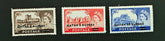 Three vintage postage stamps featuring Queen Elizabeth II on a black background