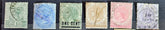A collection of vintage postage stamps from the Straits Settlements, featuring various colors and designs, displayed on a flat surface.
