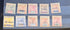 A set of ten vintage Seychelles postage stamps arranged in two rows on a dark display surface. The stamps show different denominations including 2, 4, 3 cents, 30 cents, 3, 12, and 3 cents, with various colors and postmarks.