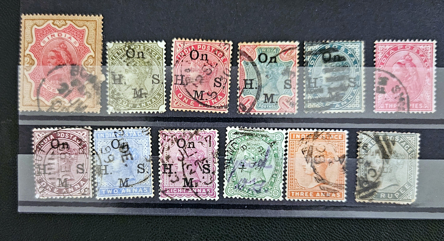 Collection of vintage stamps with different designs and colors on a black background