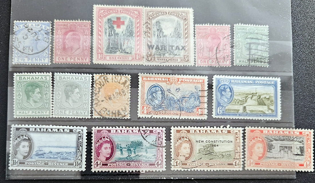 A collection of vintage Bahama postage stamps displayed on a clear plastic protector sheet against a dark textured background. The stamps feature various colors and designs, including portraits, landscapes, and historical themes.