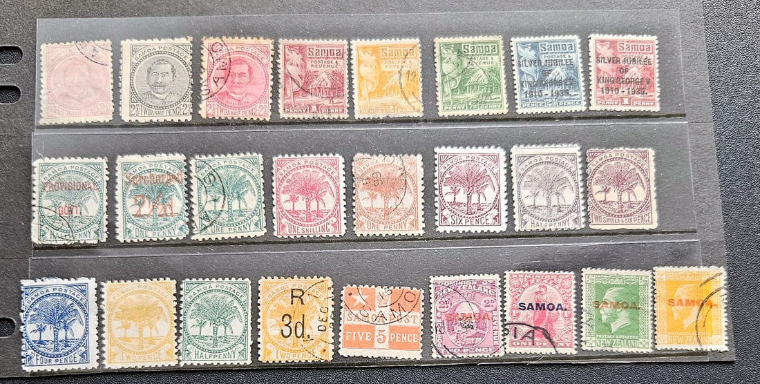 A collection of vintage Samoa postage stamps displayed in three horizontal rows on a clear plastic sleeve over a dark gray surface. The stamps feature various colors including green, pink, orange, blue, and yellow, with some showing cancellation marks.