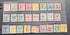A collection of vintage Samoa postage stamps displayed in three horizontal rows on a clear plastic sleeve over a dark gray surface. The stamps feature various colors including green, pink, orange, blue, and yellow, with some showing cancellation marks.