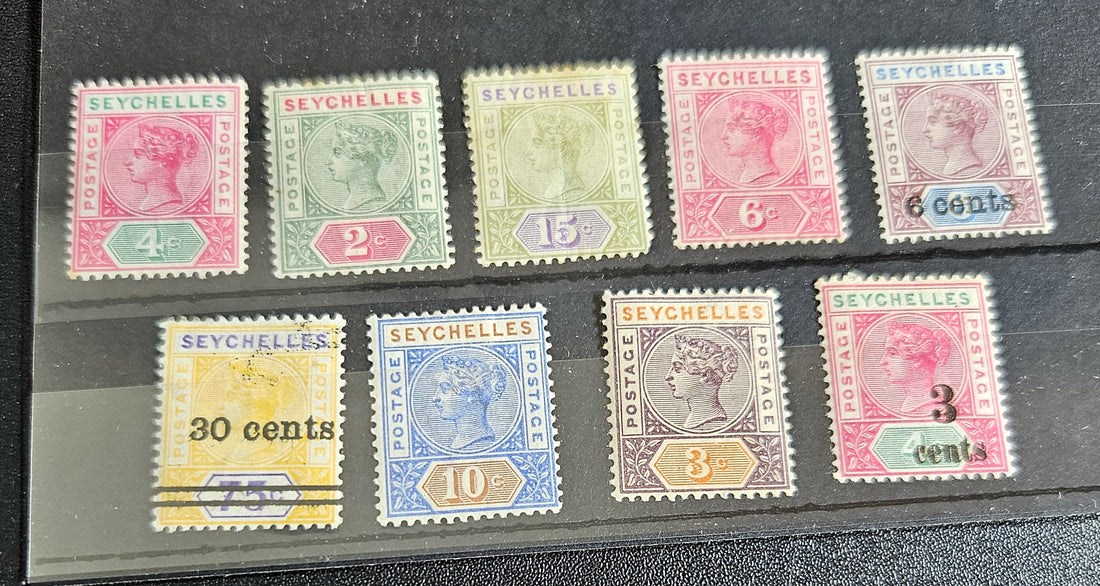 A collection of vintage Seychelles postage stamps displayed in a row, featuring various colors and denominations.