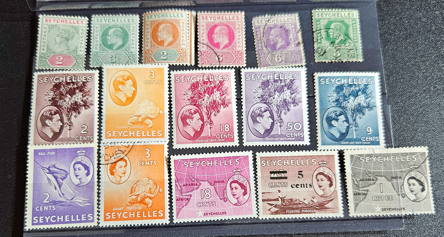 A collection of vintage Seychelles postage stamps displayed in a row, featuring various colors and denominations.