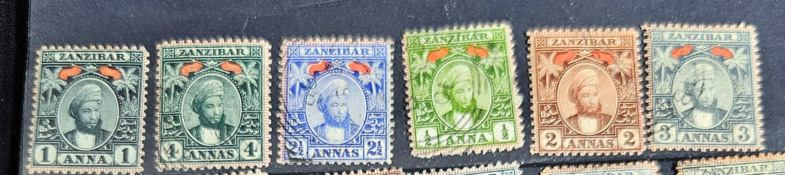 A collection of vintage Zanzibar stamps with various colors and designs, displayed horizontally.