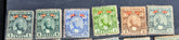 A collection of vintage Zanzibar stamps with various colors and designs, displayed horizontally.