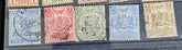 A collection of vintage Zanzibar stamps with various colors and designs, displayed horizontally.