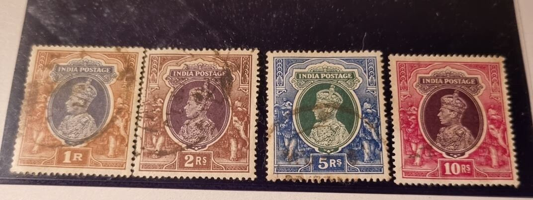 A selection of vintage India stamps from various regions and periods, displayed in a row.
