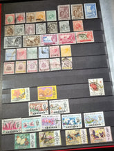 A collection of various vintage Malay state stamps
